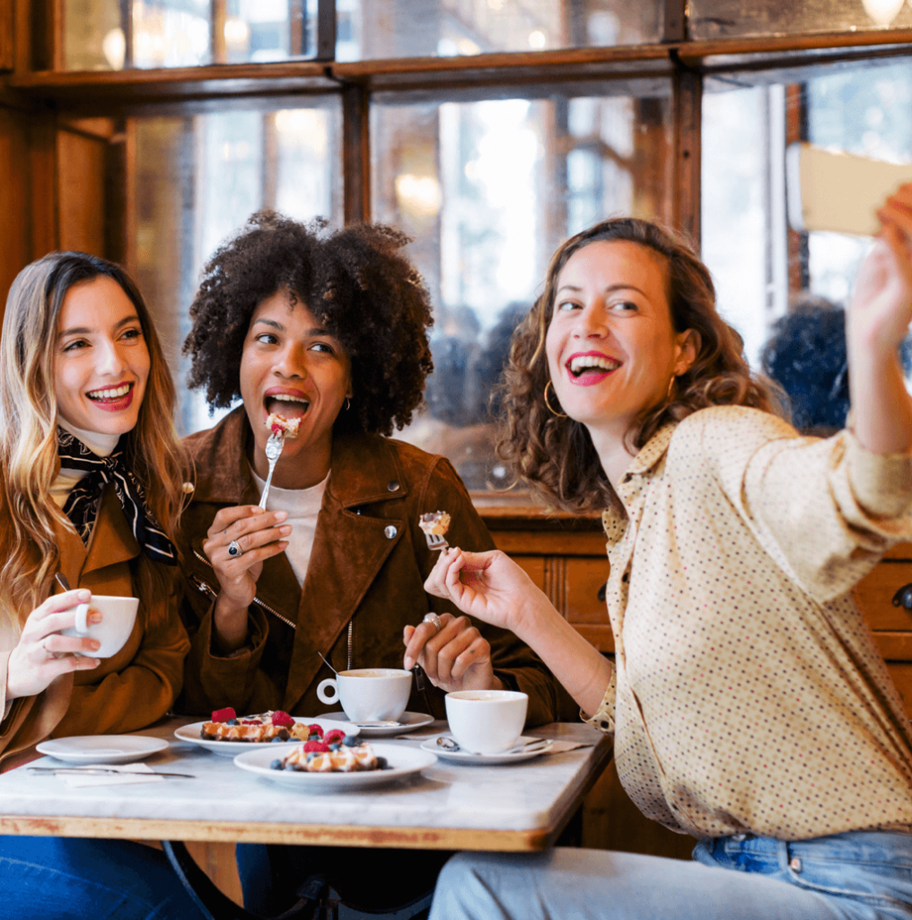 Woman taking a selfie with friends